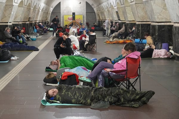 People rest in a metro station, being used as a bomb shelter, during a Russian attack in Kyiv, Ukraine, early Thursday, July 10, 2025. (AP Photo/Efrem Lukatsky)