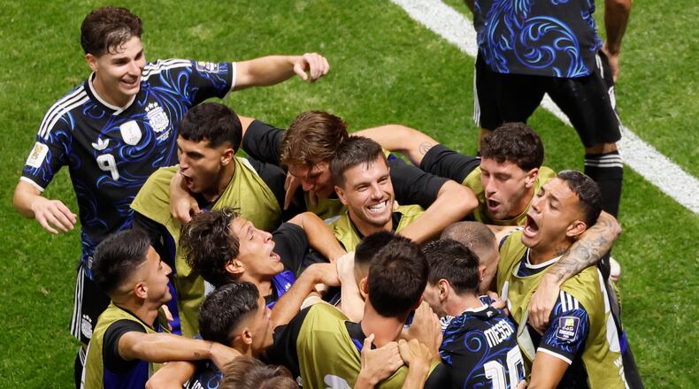Argentina's Lautaro Martinez is mobbed by teammates after the winning goal during the second half of the Argentina vs. England FIFA World Cup semifinal match at Atlanta Stadium (Mercedes-Benz Stadium) on Wednesday, July 15, 2026. (Miguel Martinez/AJC)