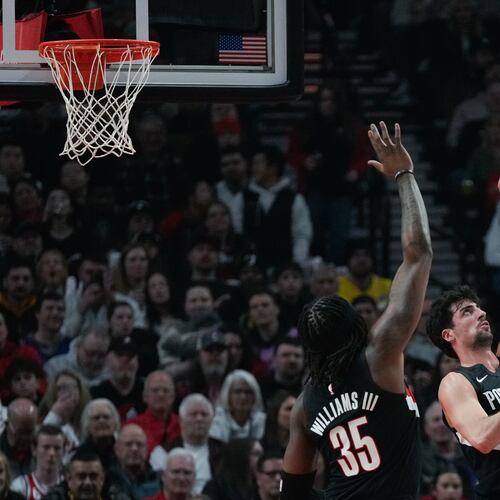 Portland Trail Blazers forward Deni Avdija (8) tries to block a shot by Denver Nuggets center Nikola Jokić (15) during the first half of an NBA basketball game Friday, Feb. 20, 2026, in Portland, Ore. (AP Photo/Jenny Kane)