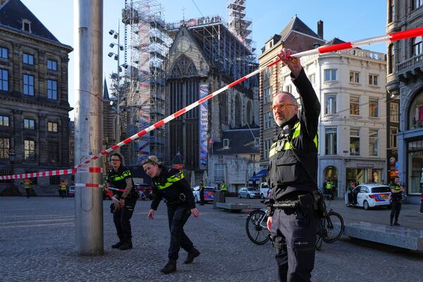 Police officers cordon-off an area after a stabbing near Dam Square in central Amsterdam, Thursday, March 27, 2025. (AP Photo/Peter Delong)