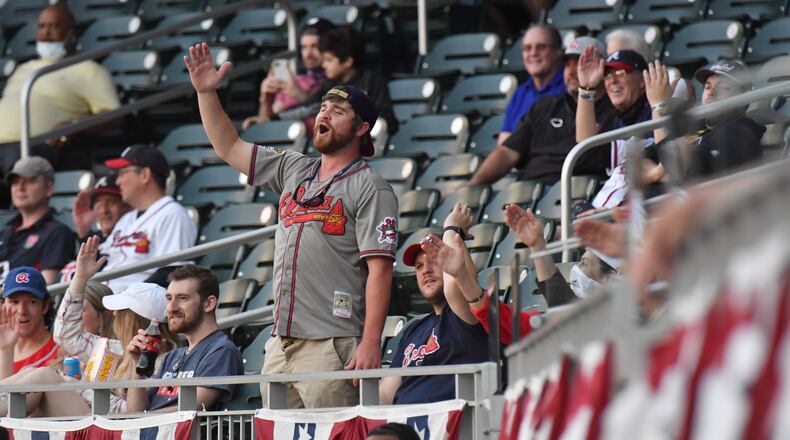 Braves fans perform the "Tomahawk Chop" in the first inning Sunday, April 11, 2021, at Truist Park in Atlanta. (Hyosub Shin / Hyosub.Shin@ajc.com)