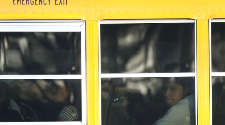 A 3-year-old boy was left strapped on a school bus for more than an hour, his mother said.