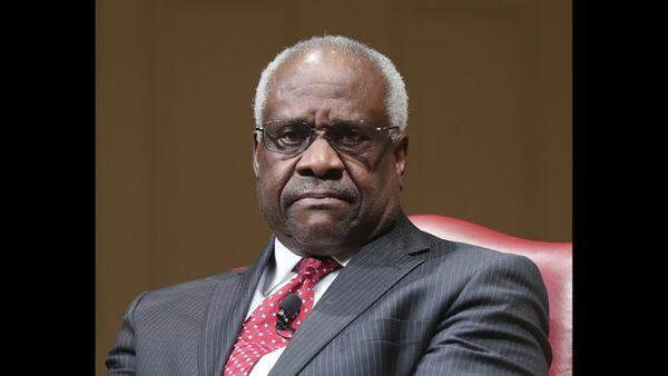 In this February 2018 file photo, Supreme Court Justice Clarence Thomas sits as he is introduced during an event at the Library of Congress in Washington. When Thomas arrived at the Supreme Court in the fall of 1991 after a bruising confirmation hearing in which his former employee Anita Hill accused him of sexual harassment, fellow Justice Byron White said something that stuck with him. “It doesn’t matter how you got here. All that matters now is what you do here,” Thomas recounted in his 2007 memoir, “My Grandfather’s Son.” (AP Photo/Pablo Martinez Monsivais, File) 