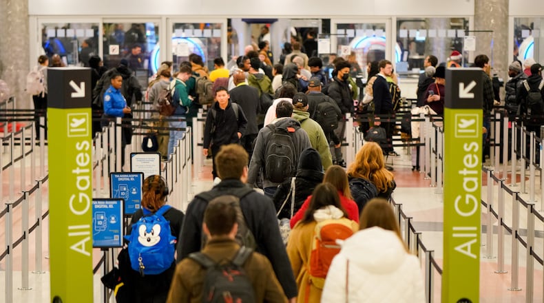 Travelers descend on Hartsfield-Jackson Atlanta International Airport in the final days of the holiday season. Friday, December 20, 2024 (Ben Hendren for the Atlanta Journal-Constitution)