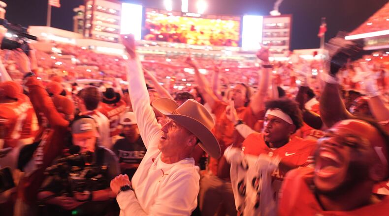Texas head coach Steve Sarkisian, center and Texas players celebrate their win over Ohio State in an NCAA college football game in Austin, Texas, Saturday, Sept. 12, 2026. (AP Photo/Eric Gay)