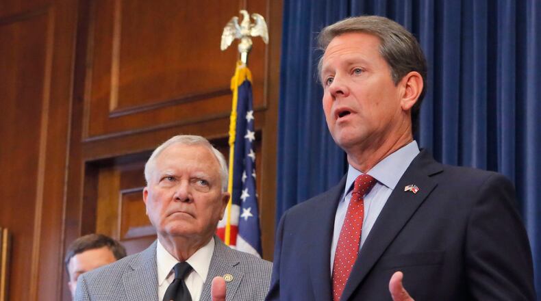 Republican Brian Kemp and Gov. Nathan Deal at last week’s press conference at the state Capitol. Kemp declared himself the victor in the 2018 race for governor, but Democrat Stacey Abrams has yet to concede. BOB ANDRES / BANDRES@AJC.COM