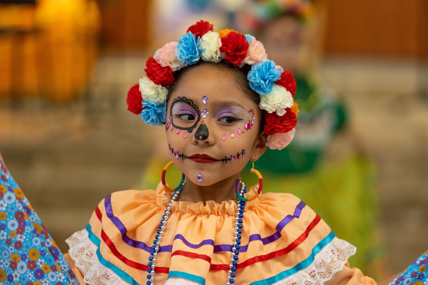 A girl prepares to perform at the Dia de Los Muertos Festival hosted by the Atlanta Symphony Orchestra at the Woodruff Arts Center on Sunday, October 30, 2022. (Photo: Jenn Finch for The Atlanta Journal-Constitution)


