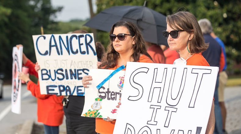 08/02/2019 -- Smyrna, Georgia -- Sherry Corey (right) and Laura Barnes (center) protest against Sterigenics near the Sterigenics plant in Smyrna, Friday, August 2, 2019.  (Alyssa Pointer/alyssa.pointer@ajc.com)