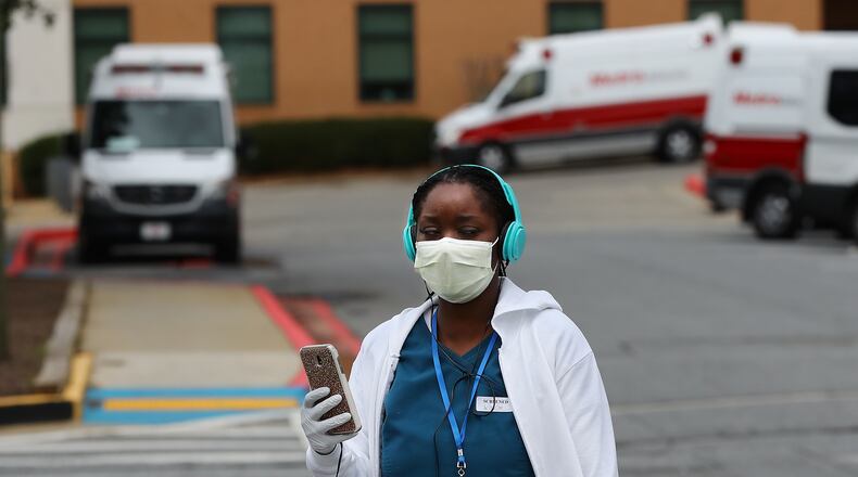 March 12, 2020 Kennesaw: A nurse wearing a mask and gloves for protection from the coronavirus walks past ambulances as she leaves Wellstar Kennestone on the afternoon that Georgia authorities confirmed the stateâs first coronavirus related death, a 67-year-old male hospitalized here on Thursday, March 12, 2020, in Kennesaw.   Curtis Compton ccompton@ajc.com