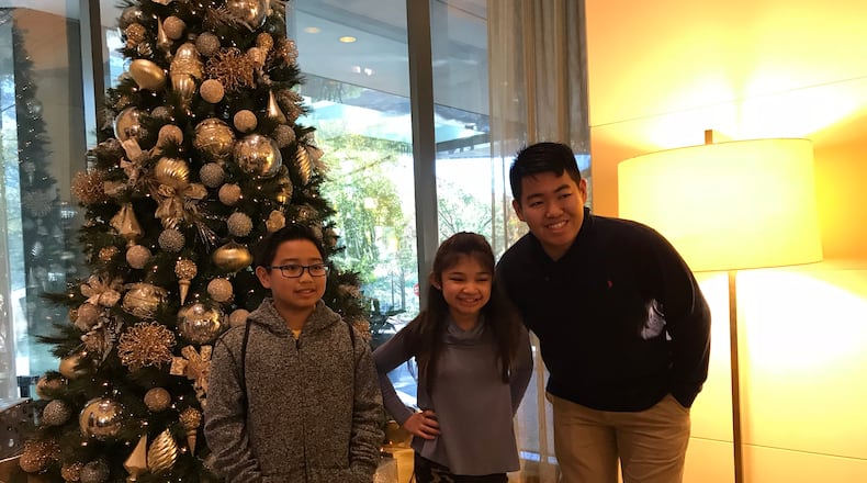 Angelica Hale poses with two fans Marvin (rightr) and Martin (left) in the J.W. Marriott lobby by Lenox November 20, 2017. CREDIT: Rodney Ho/rho@ajc.com