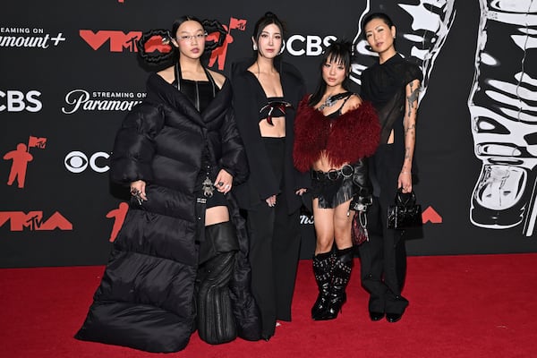 From left, "KPop Demon Hunters" voice actors Audrey Nuna, Ejae, Rei Ami and May Hong arrive at the MTV Video Music Awards earlier this month. Hong provides the speaking voice for the character Mira, while the singing voices are provided by Nuna (Mira), Ejae (Rumi) and Ami (Zoey). (Evan Agostini/AP)