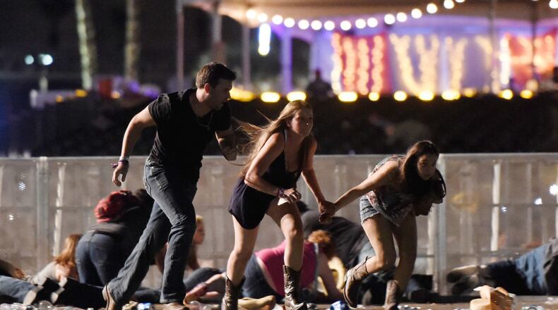 People run from the Route 91 Harvest country music festival after shots were fired on Oct. 1 in Las Vegas.