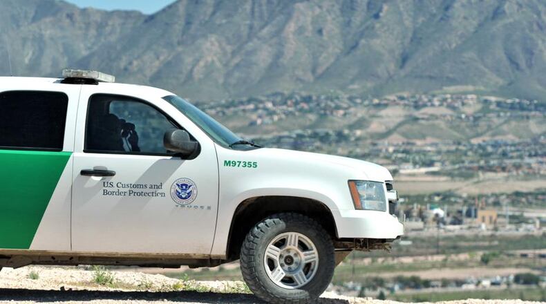 A Border Patrol agent looks over the town of Anapra, Mexico, along a border fence near the border with Sunland Park, N.M., on Thursday, September 26, 2013. HYOSUB SHIN / HSHIN@AJC.COM