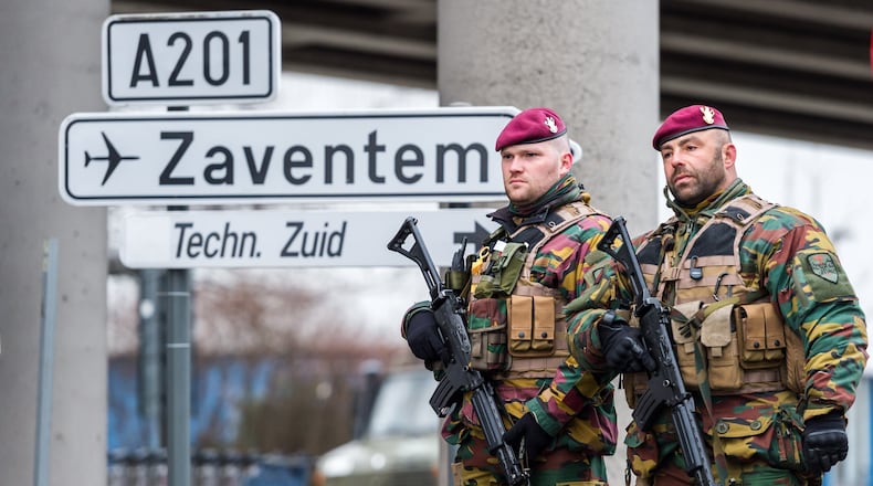 Belgian Army soldiers patrol at Zaventem Airport in Brussels on Wednesday, March 23, 2016. Belgian authorities were searching Wednesday for a top suspect in the country's deadliest attacks in decades, as the European Union's capital awoke under guard and with limited public transport after 34 were killed in bombings on the Brussels airport and a subway station.