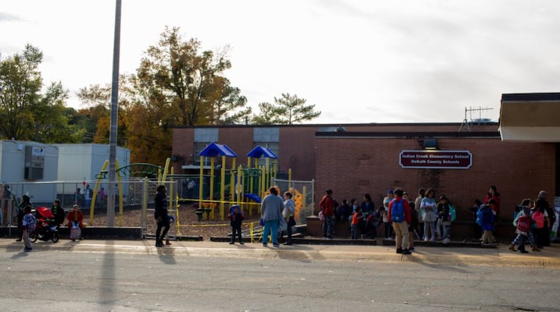 Students and parents walk outside of Indian Creek Elementary School in Clarkston in this older photo from Nov. 21, 2019. (Photo/Rebecca Wright for the Atlanta Journal-Constitution)