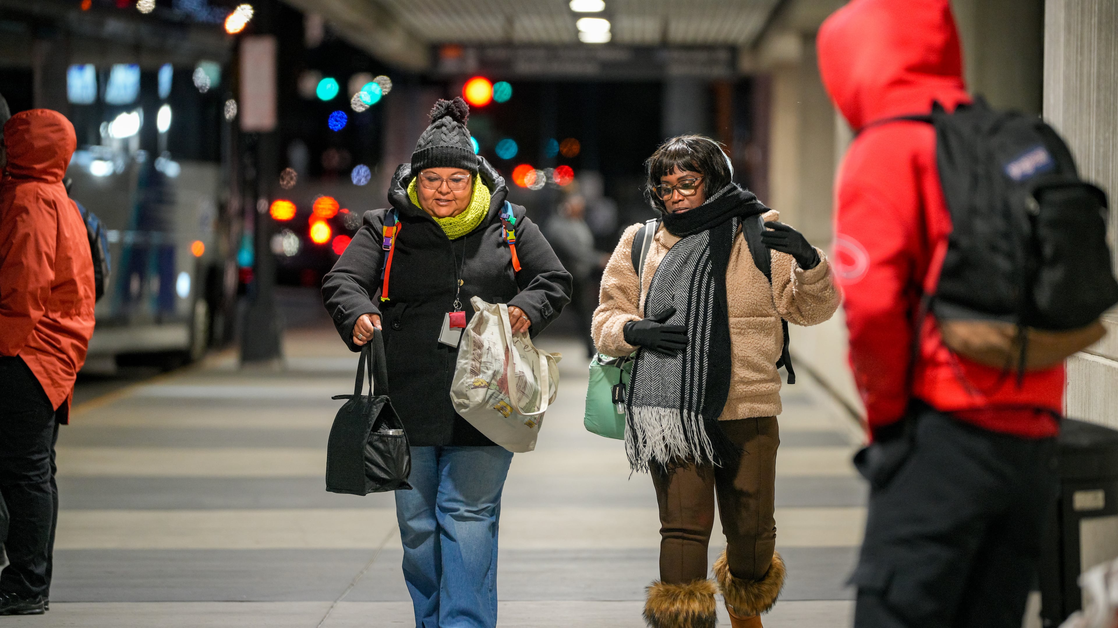 Two women, well wrapped up against the freezing weather, leave the Civic Center MARTA station in Atlanta, Monday, Nov. 10, 2025 (Ben Hendren for the AJC)