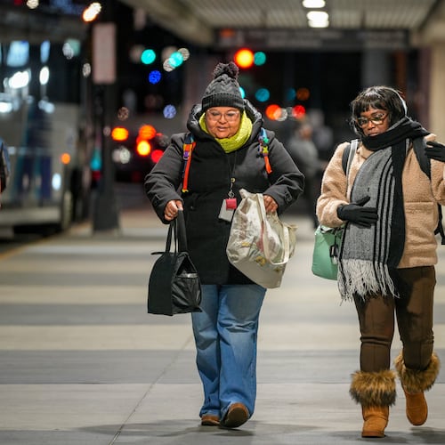 Two women, well wrapped up against the freezing weather, leave the Civic Center MARTA station in Atlanta, Monday, Nov. 10, 2025 (Ben Hendren for the AJC)