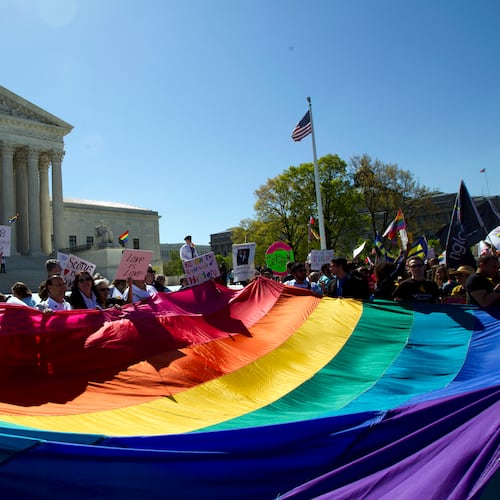 Demonstrators hold a pride flag outside the Supreme Court in Washington as justices deliberate Obergefell v. Hodges, the case that legalized same-sex marriage nationwide, on April 28, 2015. (Jose Luis Magana/AP 2015)