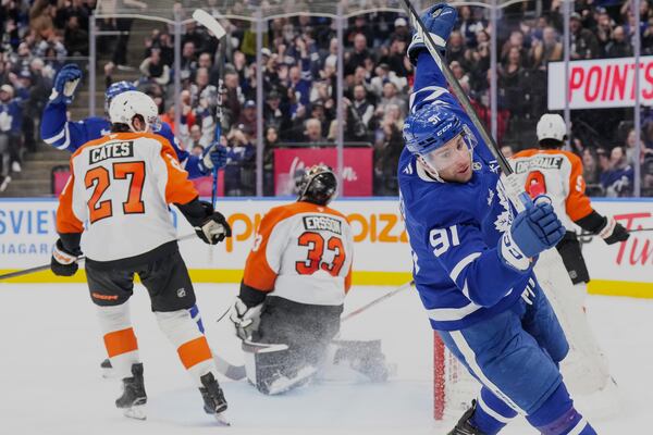 Toronto Maple Leafs' John Tavares (91) celebrates after scoring on Philadelphia Flyers goaltender Samuel Ersson (33) during second period NHL hockey action in Toronto on Tuesday, March 25, 2025. (Chris Young/The Canadian Press via AP)