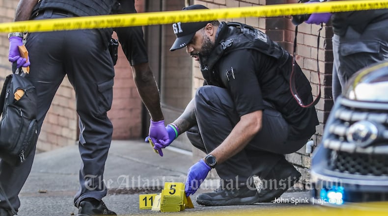 Atlanta police collect evidence from the scene of a double shooting Friday morning.