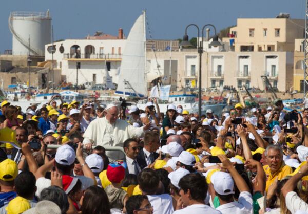 FILE - Pope Francis waves to faithful as he is driven through the crowd during his visit to the island of Lampedusa, southern Italy, on July 8, 2013, where he denounced the "globalization of indifference" that greets migrants who risk their lives trying to reach Europe. (AP Photo/Alessandra Tarantino, File)