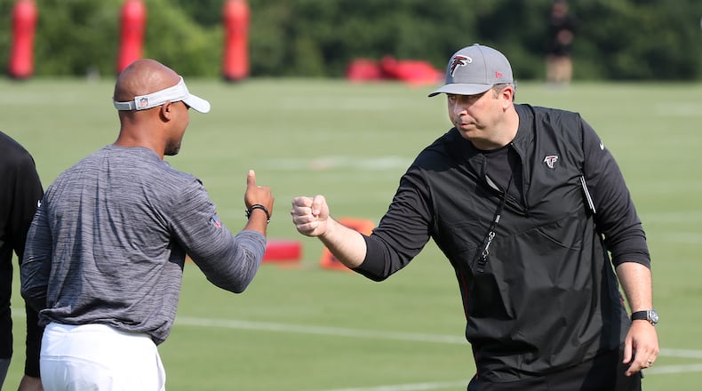 073121 Flowery Branch: Atlanta Falcons head coach Arthur Smith (right) gives general manager Terry Fontenot give each other a fist bump after speaker to Falcons fans on the third day of training camp practice on Saturday, July 31, 2021, in Flowery Branch.   “Curtis Compton / Curtis.Compton@ajc.com”