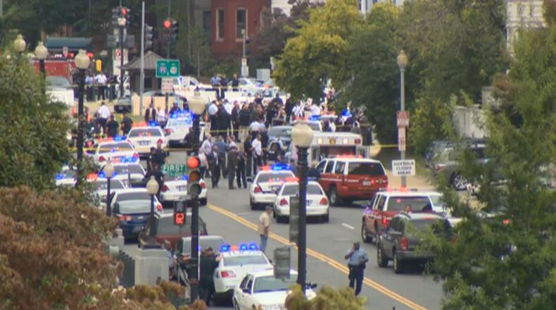 Police swarm the scene of shooting at U.S. Capitol in Washington.