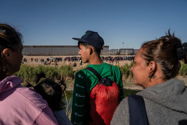 Seen from Ciudad Juarez, Mexico: asylum-seeking migrants mostly from Venezuela apprehended by U.S. Border Patrol and U.S. National Guards after crossing the Rio Grande into the U.S., on March 29, 2023. The Biden administration will start deporting Venezuelans who crossed into the country illegally, officials said Thursday, Oct. 5, 2023, in its latest attempt to stem the pace of migrants fleeing the humanitarian crisis in that country. (Go Nakamura/The New York Times)