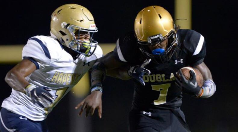 Douglass senior QB Juan Powell (7) is pursued by Hapeville Charter senior CB Malik Fleming (1) late in the first half of their game Friday, September 28, 2018 at Lakewood Stadium. PHOTO/Daniel Varnado