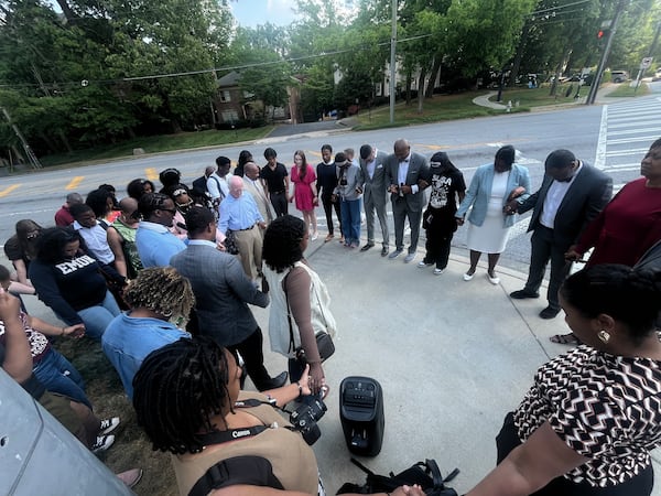 Local attorneys outside of the Emory University School of Law end their demonstration with a prayer on Thursday, April 23, 2026. The group criticized the school for how it handled a series of disturbing social media posts and threatening emails from a student. (Jason Armesto/AJC)
