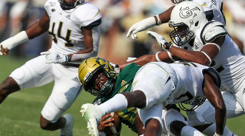 09/07/2019 -- Atlanta, Georgia -- Georgia Tech Yellow Jackets linebacker Charlie Thomas (25) tackles South Florida Bulls quarterback Jordan McCloud (12) during the second half at Bobby Dodd Stadium in Atlanta, Saturday, September 7, 2019. The Georgia Tech Yellow Jackets beat the South Florida Bulls 14-10. (Alyssa Pointer/alyssa.pointer@ajc.com)