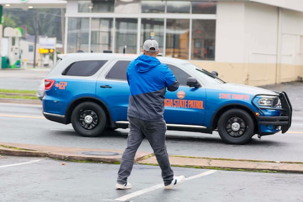 Spanish-language journalist Mario Guevara from MGNews is seen recording a Georgia state trooper leaving the scene in Gwinnett County, Ga., after collaborating with Immigration officers arresting an apparent undocumented person on Thursday, June 5, 2025. (Miguel Martinez/Atlanta Journal-Constitution via AP)