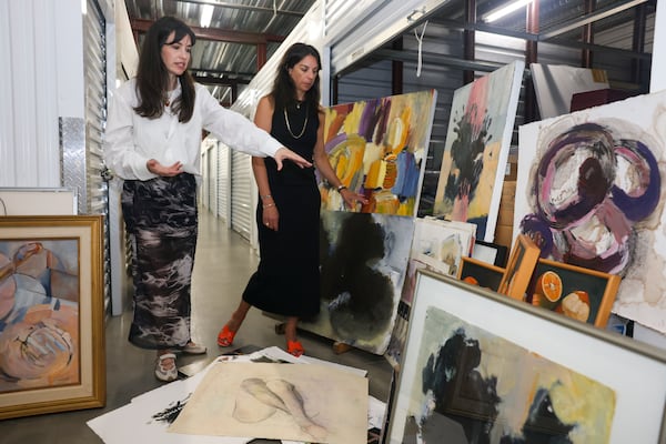 Sisters Birney Robert, left, and Georgia Robert Parmelee will be spending their first Mother's Day without their mom Susan. The art she left gives them plenty with which to appreciate her legacy. (Jason Getz/AJC)