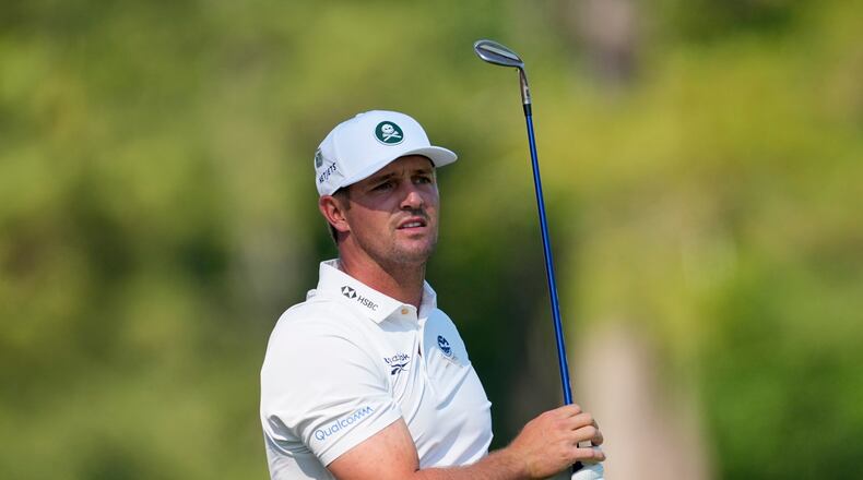 Bryson DeChambeau watches his tee shot on the 12th hole during the second round of the Masters golf tournament at the Augusta National Golf Club, Friday, April 10, 2026, in Augusta, Ga. (AP Photo/Eric Gay)