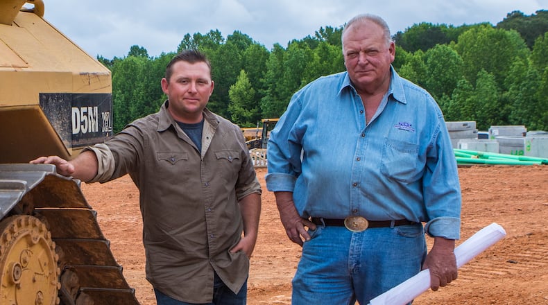 Stoney Birt, right, with son Stone Birt on the construction site for a new subdivision in Sugar Hill, contends that his father, Billy Sunday Birt, was a good father despite also being a serial murderer. Jenni Girtman for The Atlanta Journal-Constitution