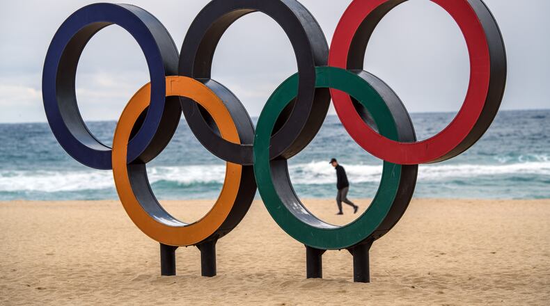 GANGNEUNG, SOUTH KOREA - FEBRUARY 02: A man walks past Olympic rings on the beach near the Gangneung Coastal Cluster on February 2, 2018 in Gangneung, South Korea. Finishing touches are being completed as teams begin to arrive from around the world to take part in the 23rd Winter Olympics. (Photo by Carl Court/Getty Images)