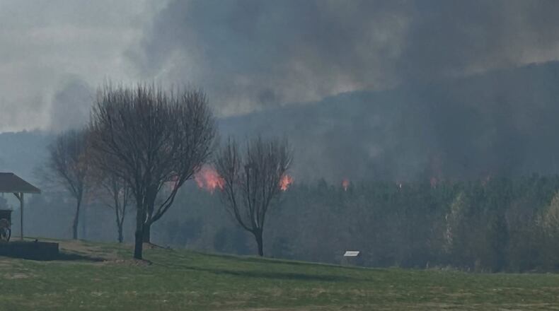 Firefighters in Floyd County battled a wildfire that engulfed several acres of forest that prompted evacuations Sunday.