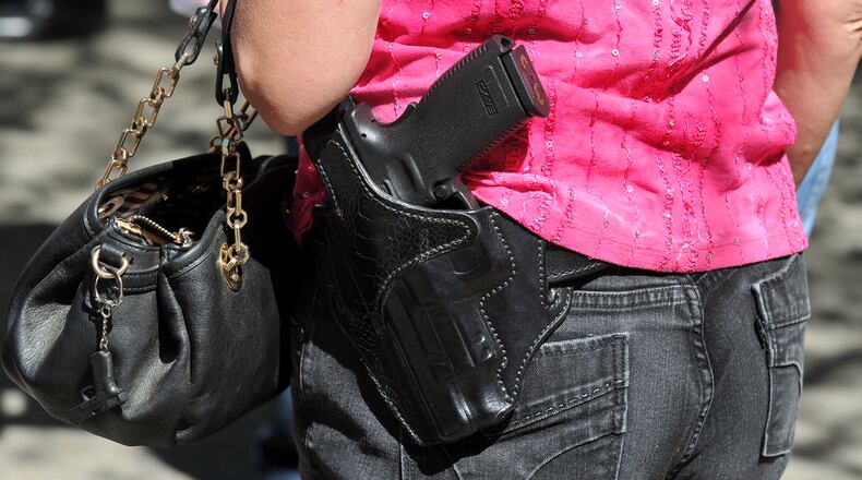 April 23, 2014. Ellijay, GA: Cindy Wheeler carries her gun while handing out buttons at a House Bill 60 signing event in Ellijay, GA Wednesday April 23, 2014. The gun bill, signed into law during the event by Governor Nathan Deal is a broad loosening of Georgia's gun restrictions. BRANT SANDERLIN /BSANDERLIN@AJC.COM .