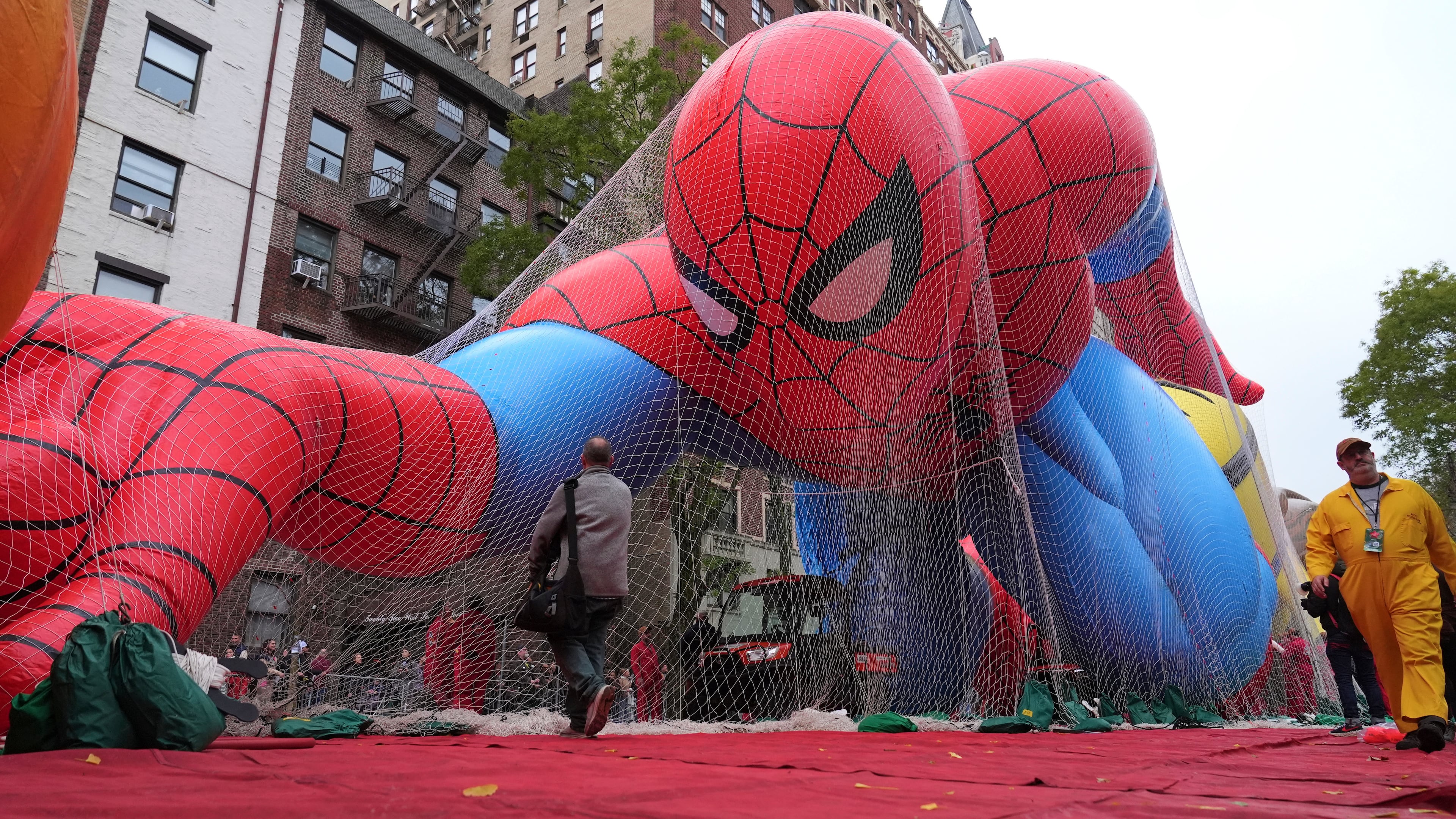 Volunteers pass a Spider-Man balloon during preparations for the 99th Macy's Thanksgiving Day Parade Wednesday, Nov. 26, 2025, in New York. (AP Photo/Frank Franklin II)