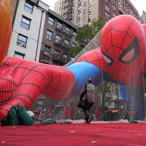 Volunteers pass a Spider-Man balloon during preparations for the 99th Macy's Thanksgiving Day Parade Wednesday, Nov. 26, 2025, in New York. (AP Photo/Frank Franklin II)