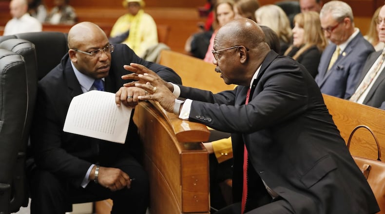 Chief Assistant District Attorney Clint Rucker (left) talks with Fulton County District Attorney Paul Howard, Jr. during the Tex McIver murder trial at the Fulton County Courthouse. Bob Andres bandres@ajc.com AJC FILE PHOTO