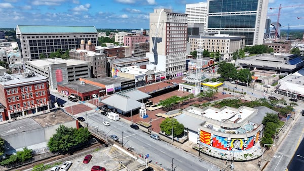 An aerial image shows three murals within three square blocks in Atlanta: "The Prayer," on the east side of the Connally Hotel on Peachtree Street; “The Liberty” mural; and a mural of a fire extinguisher. (Miguel Martinez/AJC)