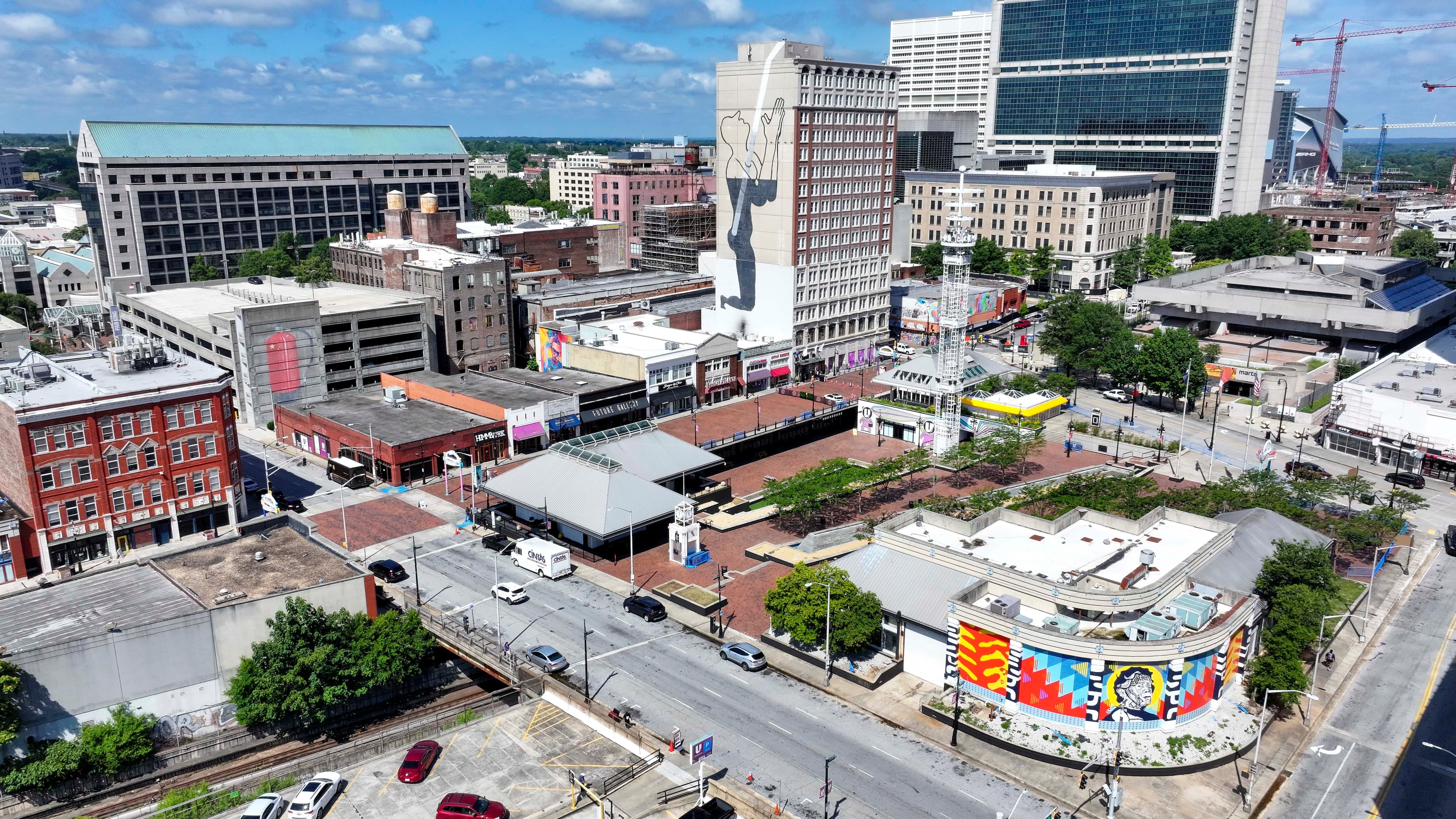 An aerial image shows three murals within three square blocks in Atlanta: "The Prayer," on the east side of the Connally Hotel on Peachtree Street; “The Liberty” mural; and a mural of a fire extinguisher. (Miguel Martinez/AJC)