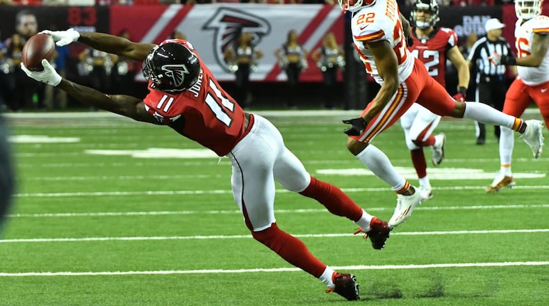 December 4, 2016 Atlanta - Atlanta Falcons wide receiver Julio Jones (11) catches a pass past Kansas City Chiefs cornerback Marcus Peters (22) during the second half in an NFL football game at the Georgia Dome on Sunday, December 4, 2016. Kansas City Chiefs won 29 - 28 over the Atlanta Falcons. HYOSUB SHIN / HSHIN@AJC.COM