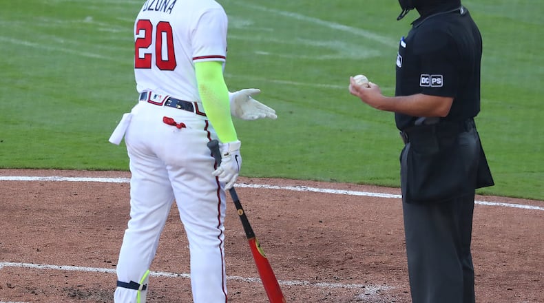 The Braves' Marcell Ozuna argues a called third strike with the home plate umpire during the fourth inning of the second game of a doubleheader against the Arizona Diamondbacks Sunday, April 25, 2021, at Truist Park in Atlanta. (Curtis Compton / Curtis.Compton@ajc.com)