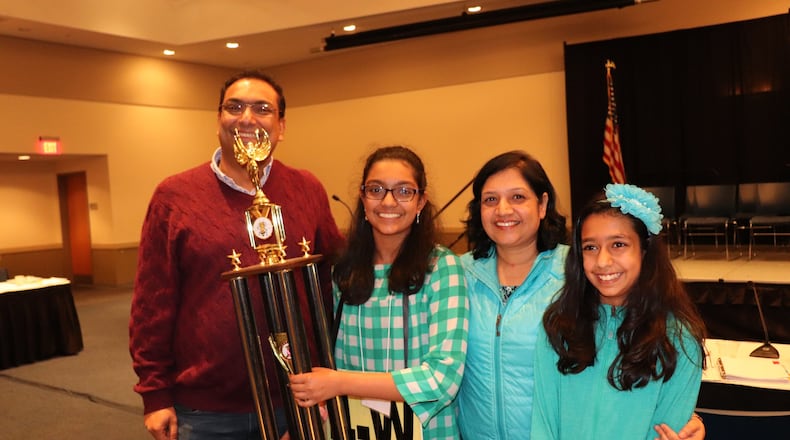 Arushi Cumer, age 13, holds her trophy after winning the 58th Georgia Association of Educators State Spelling Bee on Friday, March 15, 2019. She won on the word “andouille” in the 17th round.
