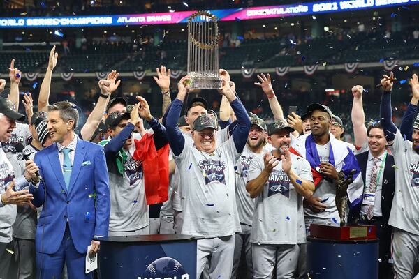 Braves manager Brian Snitker hoists the World Series trophy after beating the Astros in game 6 of the World Series on Tuesday, Nov. 2, 2021, in Houston.   “Curtis Compton / Curtis.Compton@ajc.com”