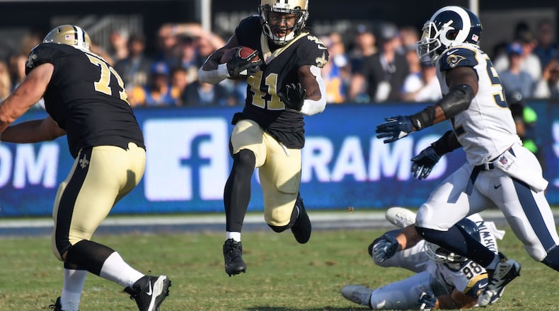 New Orleans Saints running back Alvin Kamara (41) runs away from Los Angeles Rams inside linebacker Alec Ogletree (52) and Los Angeles Rams middle linebacker Cory Littleton (58) on a second quarter play at Los Angeles Memorial Coliseum.