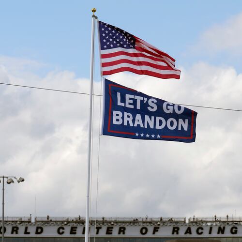 FILE - A "Let's go Brandon" flag flies below the American flag, Feb. 18, 2022, at Daytona International Speedway in Daytona Beach, Fla. (AP Photo/Chris O'Meara, File)