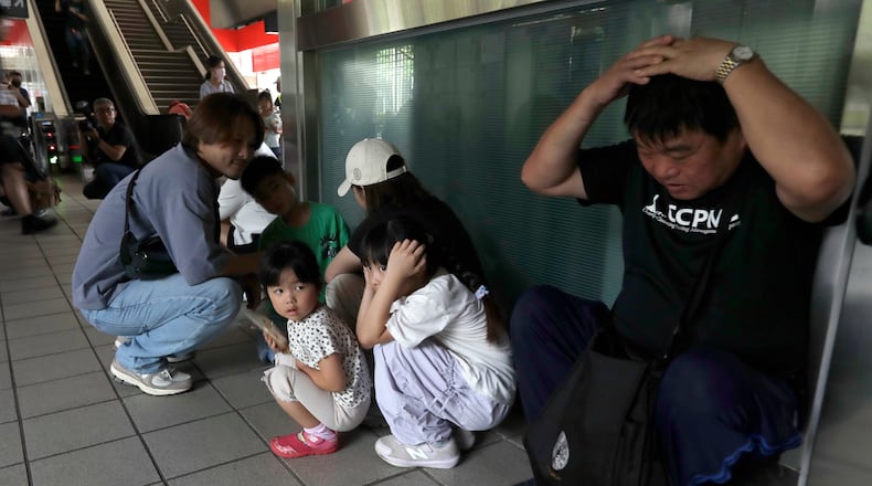 People take cover inside at a MRT station during the Urban Resilience (Air-Defense) Exercise, part of the annual Han Kuang military exercises in Taipei, Taiwan, Thursday, Aug. 13, 2026. (AP Photo/Chiang Ying-ying)